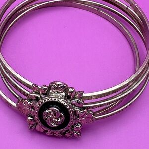 Silver stamped bangle bracelet with black flower